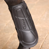 Black horse boot on lower limb on faded background 'Arma' logo