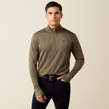 Ariat Men's Team EQ 1/2 Zip Pullover Varient Kalamanta. Man wearing a khaki long sleeve top with 1/2 zip detailing and black trousers. 