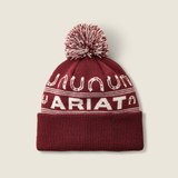 Ariat Ladies Apres Ski Beanie Varient Burgundy. Red and White beanie with large Ariat branding and horse shoe detailing with a red and white pom pom on a light background. 