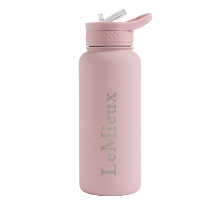 LeMieux AW26 Drinks Bottle Varient Wild Rose. A matte light pink water bottle with a matching pink flip-straw lid, featuring the brand name 'LeMieux' printed vertically in a muted gray-green font on the front, set against a plain white background.