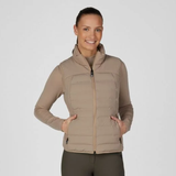 Pikeur AW26 Athleisure Quilted Flexvest Variant Mocha Cream. A woman modeling a light brown puffer vest over a matching long-sleeve top and dark gray pants, set against a plain light gray studio background.