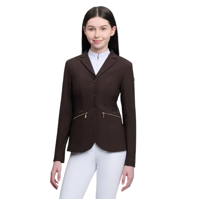Woman wearing a brown equestrian jacket with zippers on a white background