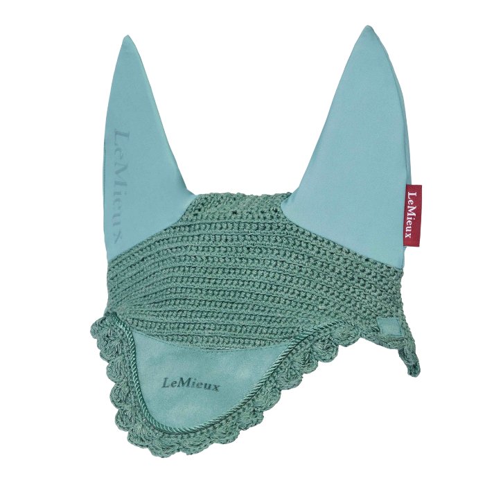 LeMieux AW26 Classic Fly Hood Variant Aloe. A light blue equestrian ear bonnet with a textured crochet center band and scalloped trim, featuring the LeMieux brand name on the ear tips and a small red brand tag.