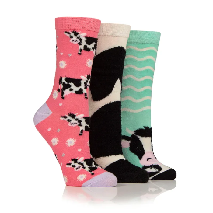 three coloured socks with cows and stripe on white background