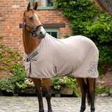 Horse stands wearing the LeMieux Kudos Bamboo Cooler Rug in Pecan