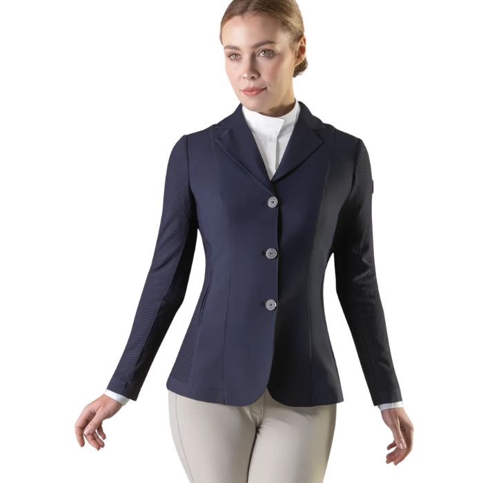 Woman wearing a navy blue riding jacket on a white background