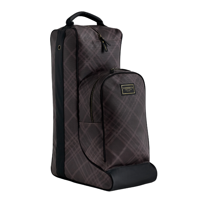 A dark brown and black plaid horse boot bag with a top handle, front zippered pocket, and a small gold-toned LeMieux Heritage logo patch, shown on a plain white background.
