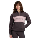 Girl wearing a brown 1/4 zip with a pink middle panel and 'LEMIEUX HERITAGE' branding.