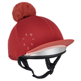 LeMieux AW26 Classique Pom Hat Silk Variant Colour Russet
A red equestrian riding helmet with a matching red pom-pom, a coral-colored visor, a silver glitter inner lining, and black chin straps. The brand name 'LEMIEUX' is printed in white on the side.
