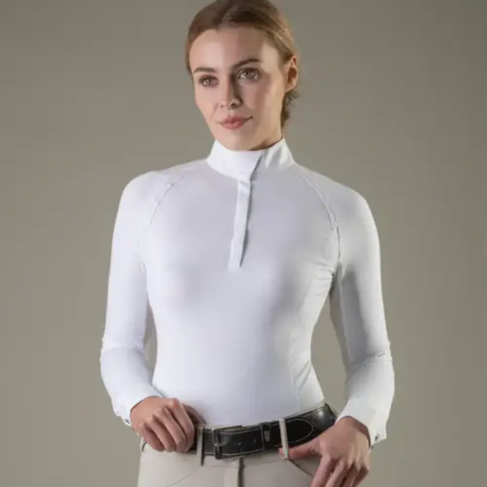 Woman wearing a white long-sleeve top against a gray background