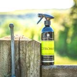 Black and green bottle on gate of fly repellent