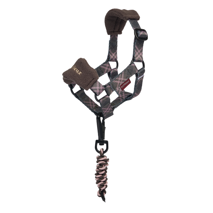 Plaid horse head collar in brown and pink against a white background. 