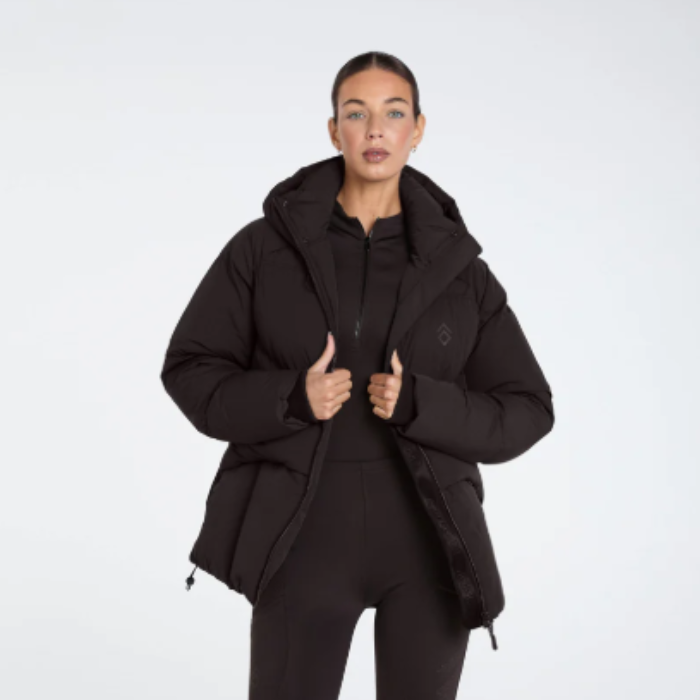 Person wearing a expresso puffer jacket on a white background