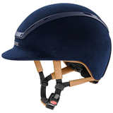 Navy riding helmet with brown straps on a white background