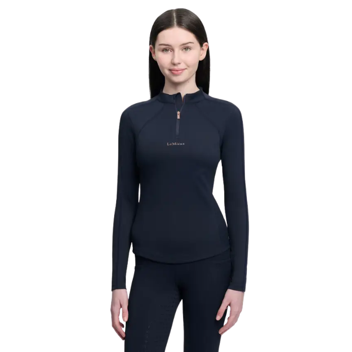 Person in navy long sleeve 'LeMieux' top and leggings on white background