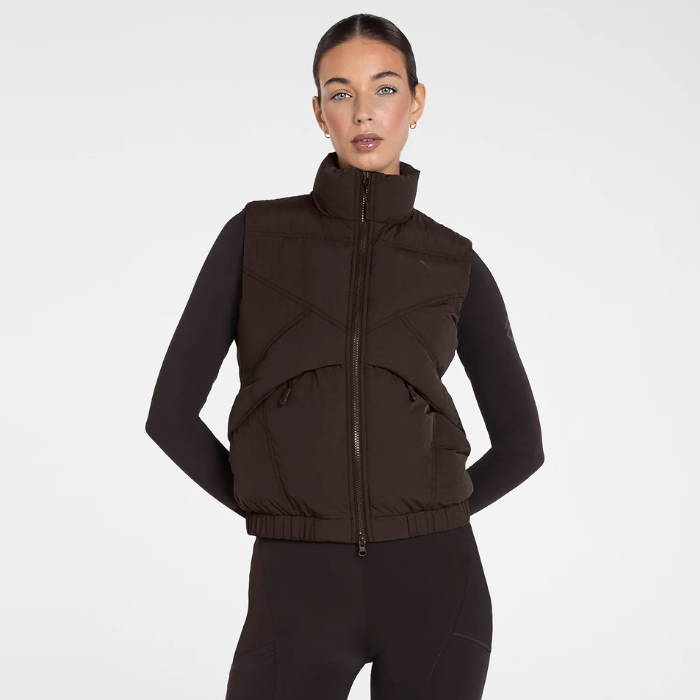 Aztec Diamond Core Mid-Layer Gilet Variant Espresso. Lady wearing a brown gilet with a matching base layer and leggings against a grey background. 