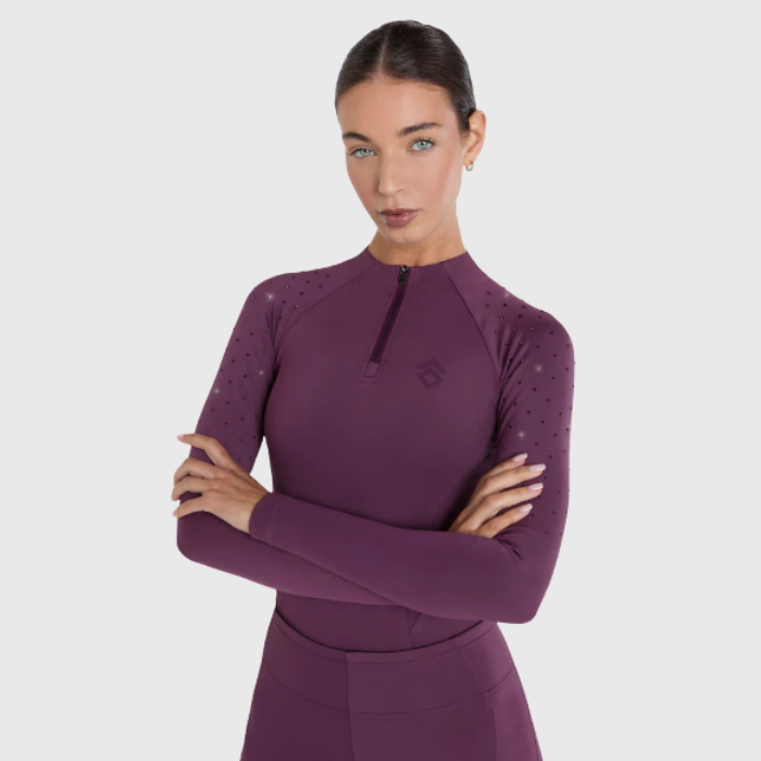 Woman wearing a plum base layer on a white background