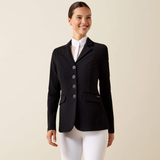Woman wearing a black blazer over a white shirt and pants on a beige background