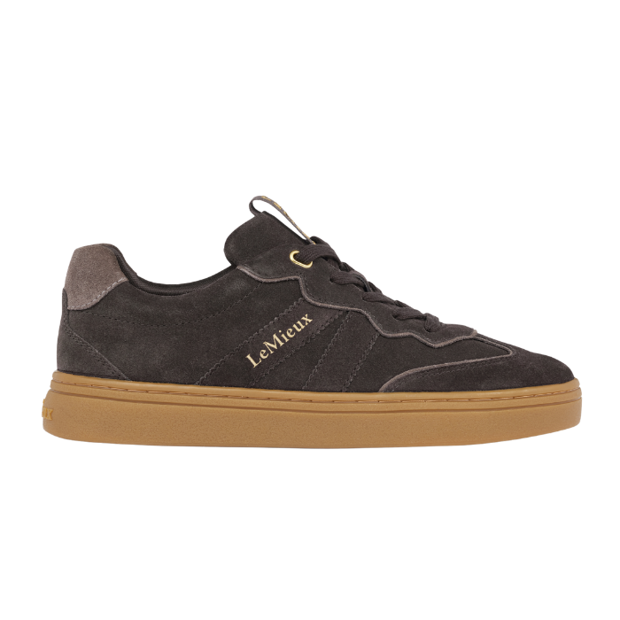 LeMieux AW26 Stockbridge Suede Trainers Variant Colour Cocoa.
A brown suede sneaker with a gum brown sole, featuring gold 'LE MiEUX' branding on the side, shown against a plain white background.