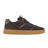 LeMieux AW26 Stockbridge Suede Trainers Variant Colour Cocoa.
A brown suede sneaker with a gum brown sole, featuring gold 'LE MiEUX' branding on the side, shown against a plain white background.