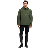 LeMieux AW26 Mens Waterproof Anorak Varient Olive. A man modeling an olive green hooded pullover jacket with a half-zip front, paired with black riding breeches and tall black riding boots, against a solid white background.