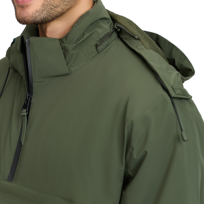 LeMieux AW26 Mens Waterproof Anorak Varient Olive. Close-up of a man wearing an olive green hooded jacket, showing the collar, zipper, shoulder, and part of the neck against a plain white background.