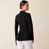 Woman wearing a black blazer and white pants on a beige background