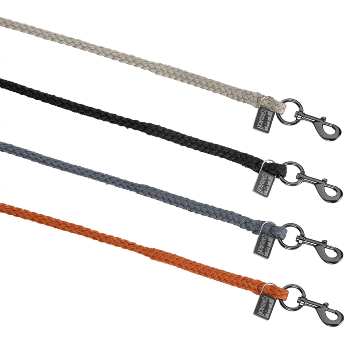 Four braided rope dog leashes in light gray, black, slate blue, and rust orange, each with a dark metal swivel snap hook and a small branded tag, shown on a white background.