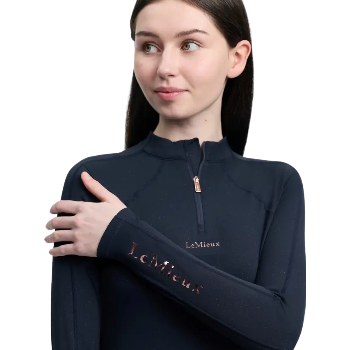Woman wearing a navy blue long-sleeve top with 'LeMieux' branding on a white background