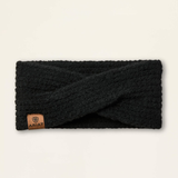 Ariat Ladies Chilton Headband Variat Black. A black textured knit twist-front ear warmer with a small brown leather ARIAT brand tab on the lower left, displayed flat against a light cream background.
