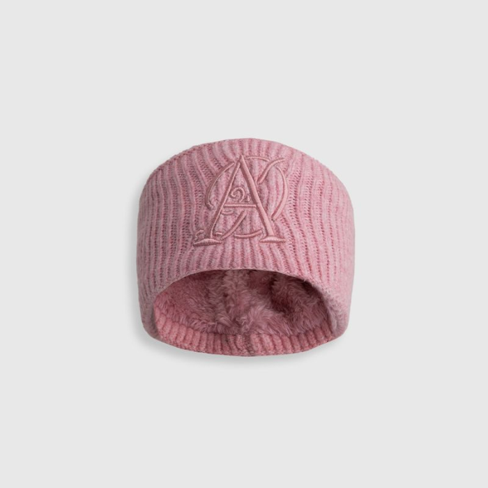 Pink knit beanie with a logo on a light gray background