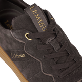 LeMieux AW26 Stockbridge Suede Trainers Variant Colour Cocoa. A close up of a brown suede shoe with 'LeMieux' brand name is gold colour. on white background.