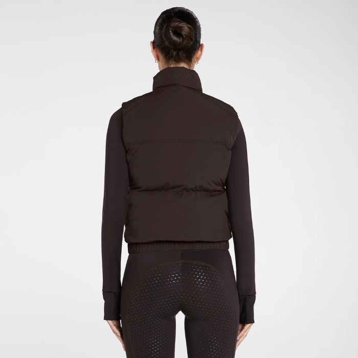 Aztec Diamond Core Mid-Layer Gilet Variant Espresso. Back of lady wearing a brown puffa gilet against a greay background.  