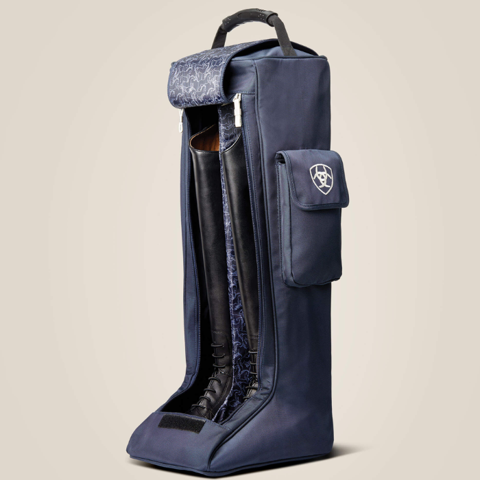 A Navy boot bag shown open with two leather boots and horse print inside against a beige background. 