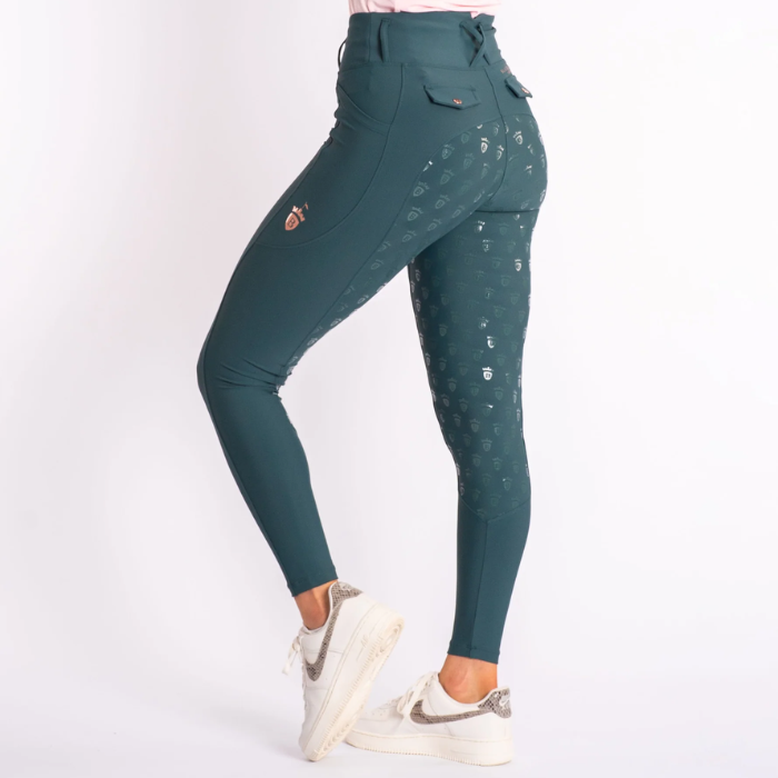 Green leggings with patterned design worn by a person on a white background