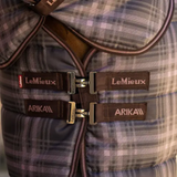 Close up of a check horse rug with a T-bar fastening. 