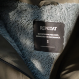 Reincoat Smock Pro Variant Olive. Inside of a Olive jacket with a fleece lining and 'REINCOAT' label. 