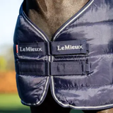 LeMieux AW26 Rug Liner 100g Variant Colour Navy. A close up of a navy horse rug showing front fastners with 'LeMieux' brand name. 