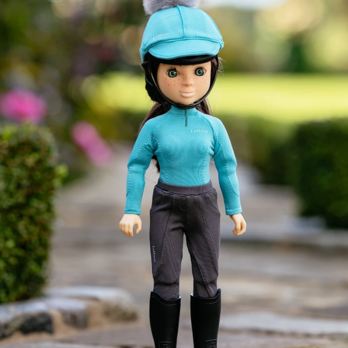 Doll wearing blue outfit on faded background