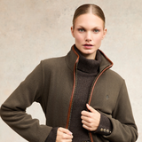 Holland Cooper Country Longline Fleece Varient Khaki. Woman wearing a high collar khaki jacket with a small HC logo on the chest.