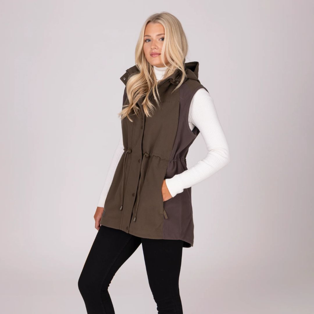 Woman wearing a brown gilet over a white shirt on a light grey background