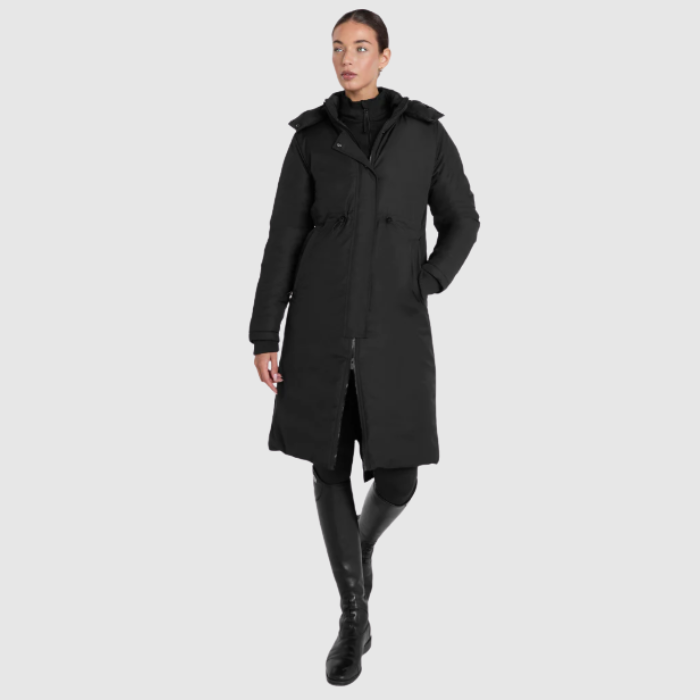 Person wearing a black coat on a light grey background