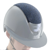 Gray equestrian helmet with blue textured top on a white background