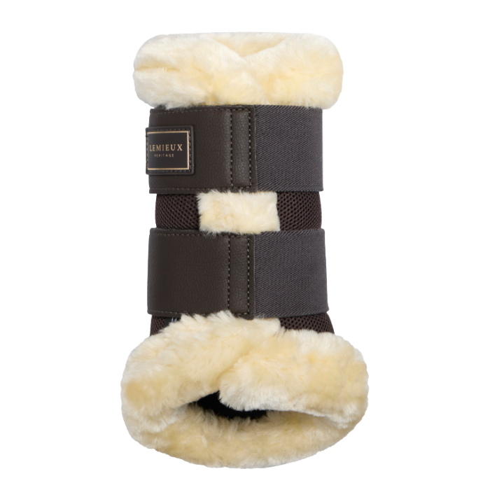 LeMieux AW26 Heritage Fleece Edged Brushing Boot Varient Cocoa. A dark brown leather horse boot with cream-colored fleece lining, featuring a brand label that reads 'LeMieux'.