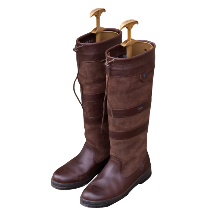 Pair of brown riding boots with gold boot tree's on a white background. 