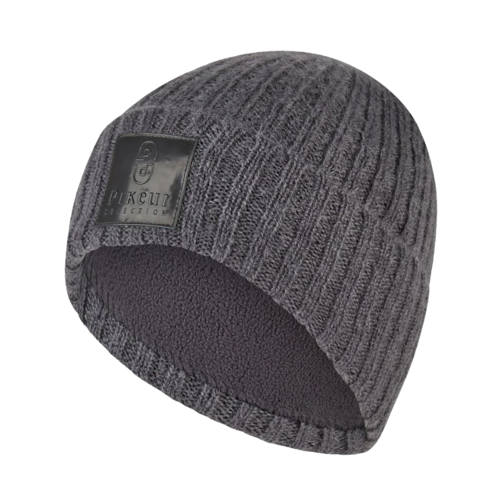 Pikeur Beanie Selection 285800 Variant Basalt Grey. .A dark gray ribbed knit beanie hat with a black rectangular brand patch on the side and a matching dark gray fleece lining visible at the opening, shown on a plain white background.