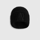 Black knit beanie with a logo on a light grey background