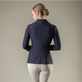Person wearing a navy blue riding jacket on a plain background
