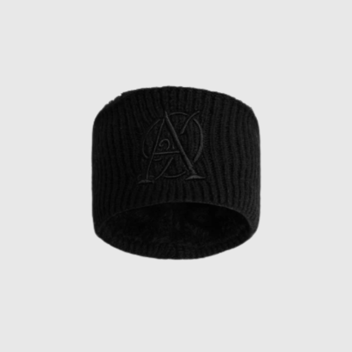 Black knit beanie with a logo on a light grey background