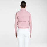 Model wearing pink gilet and white leggings on white background